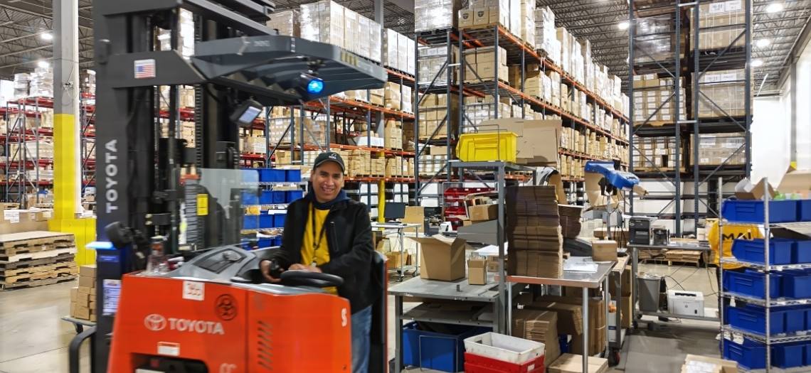 smiling employee in fulfillment warehouse